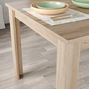 Mesa de comedor extensible Alegra con pata en L y acabado en melamina de alta calidad.