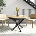Mesa de comedor redonda extensible con patas metálicas en X modelo DONATA, fabricada en España.