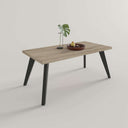 Mesa de centro fija STELLA con patas metálicas y tablero rectangular en salón moderno