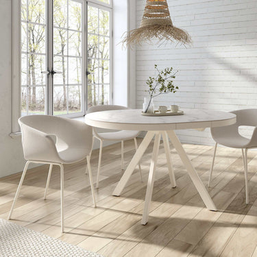 Mesa comedor redonda extensible DIVA con sobre porcelánico y base metálica disponible en varios acabados