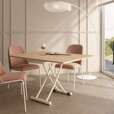 Mesa centro elevable convertible modelo CINNIA con patas metálicas en X y acabado en varios colores.