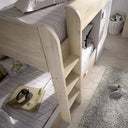 Cama tren de dos camas en madera clara y acabado blanco, con escalera integrada y armario lateral abierto.