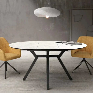 Mesa comedor redonda extensible efecto piedra con patas metálicas negras modelo GIOVANNA PIEDRA.