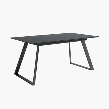 Mesa comedor extensible ROMINA PIEDRA con acabado efecto piedra y patas metálicas negras.