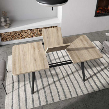 Mesa de comedor extensible AGNESE con patas trapecio y apertura semi-automática.