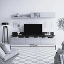 Mueble salón modular en acabado blanco y gris oscuro, con líneas minimalistas, panel para TV, estante y módulo superior con puerta.