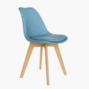 Silla de comedor azul con asiento y respaldo tapizados en tela y patas de madera clara, de líneas curvas.