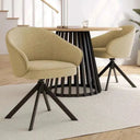 Butaca Verona tapizada con base giratoria y patas metálicas negras en salón comedor