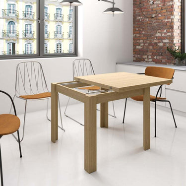 Mesa cuadrada tipo libro extensible ALESSIA con patas en L y tablero laminado natural.