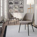 Silla de comedor tapizada en gris texturizado, con asiento y respaldo acolchados y patas metálicas negras.